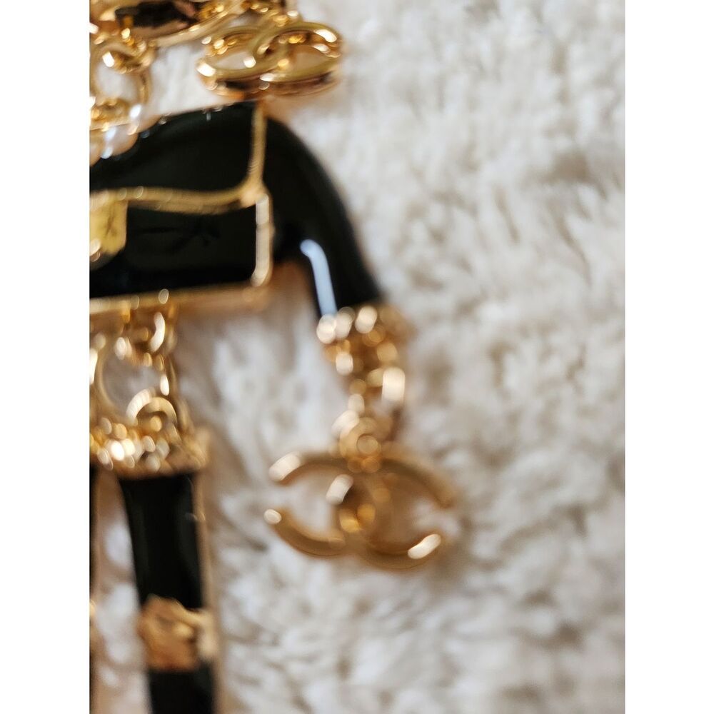 CHANEL Black and Gold Enamel Charm Doll with Pink Heart Sunglasses - Picture 2 of 7